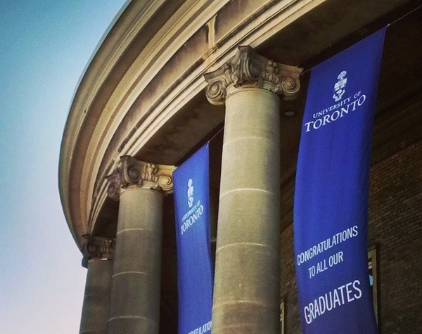 exterior of Convocation Hall with blue convocation banners hanging between columns