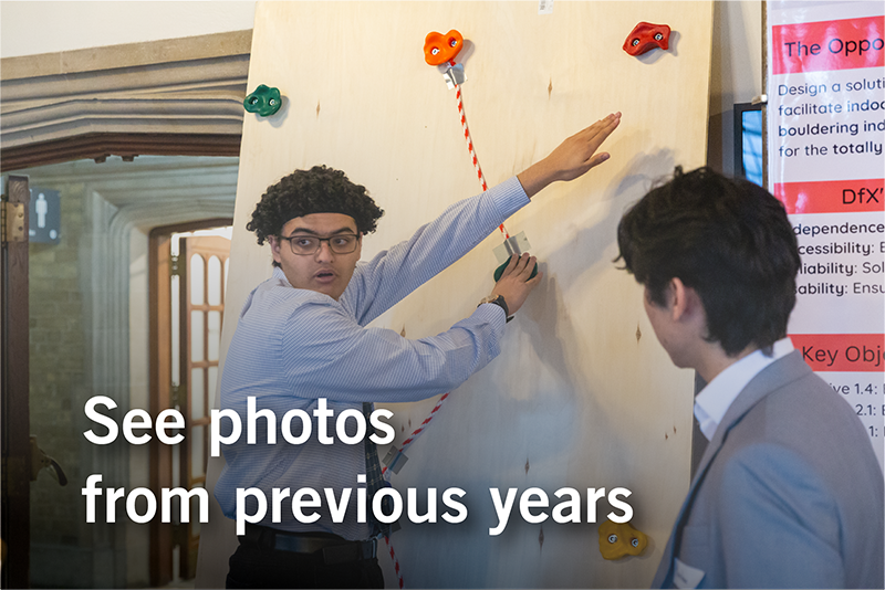 a student demonstrates an indoor climbing wall with brighly coloured holds designed for visually impaired climbers