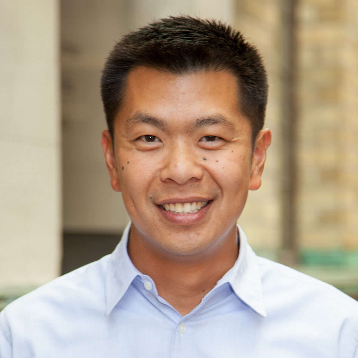 Professor Alan Chong wearing a pale blue dress shirt and smiling to camera