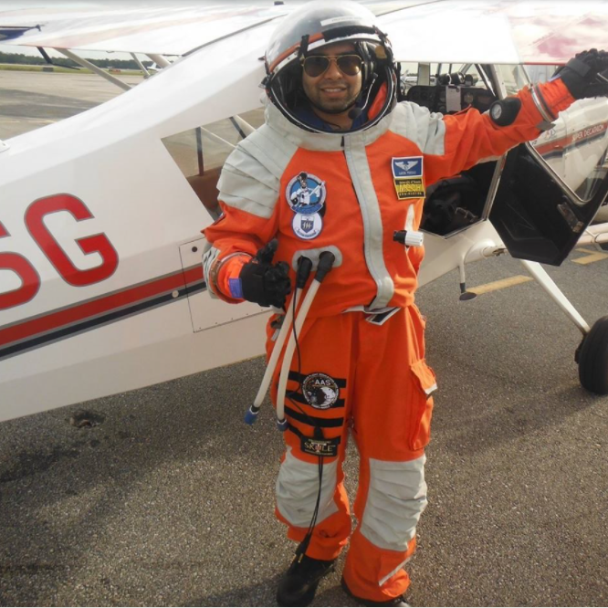 Speaker Aaron Persad next to an airplane